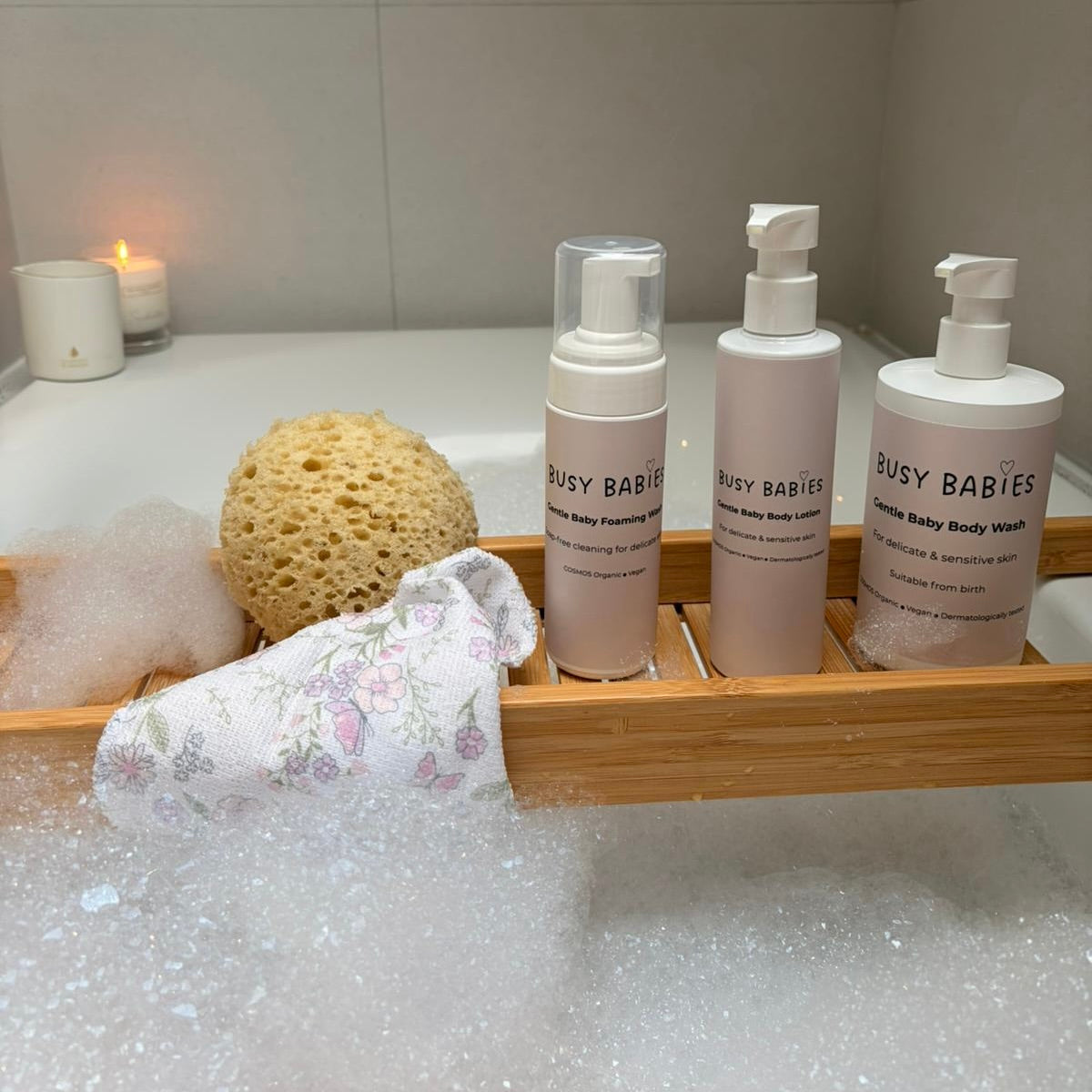 Parent bathing baby in warm water following UK NHS guidelines