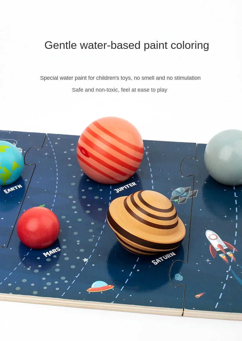 Colourful toy planets on a space-themed mat with text about water-based paint.