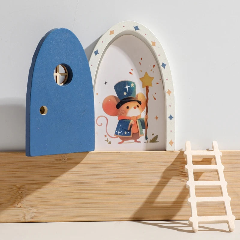 Wooden toy arch with a mouse character and blue door on a wooden shelf.