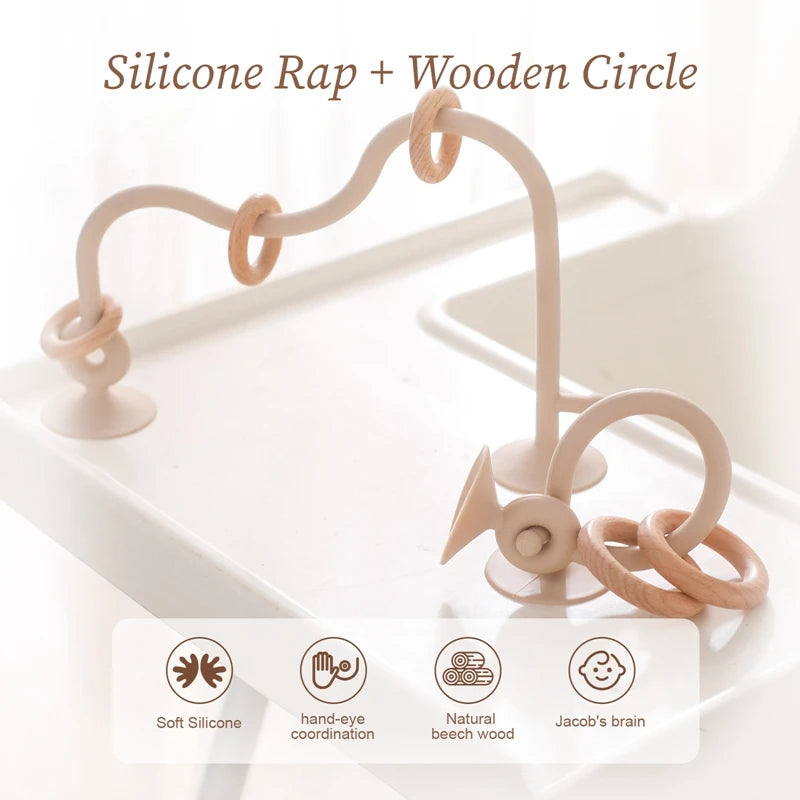 Silicone ring and wooden circle toy on a white background with text and icons.