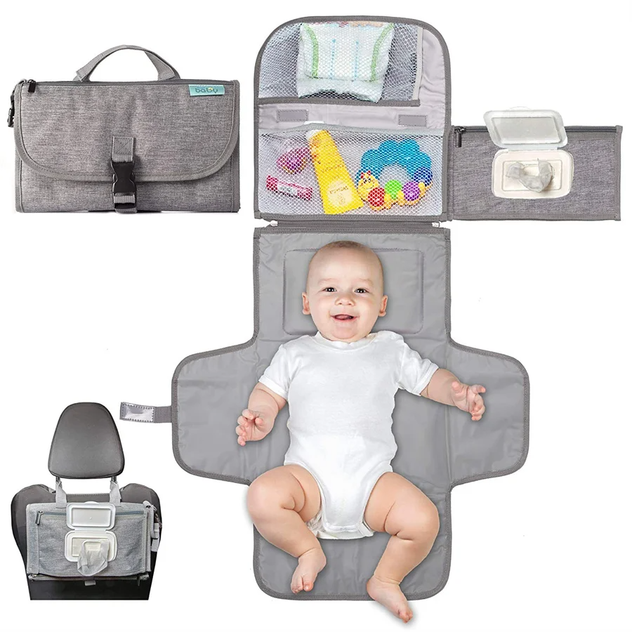 Portable foldable baby changing pad laid out with baby on the mat